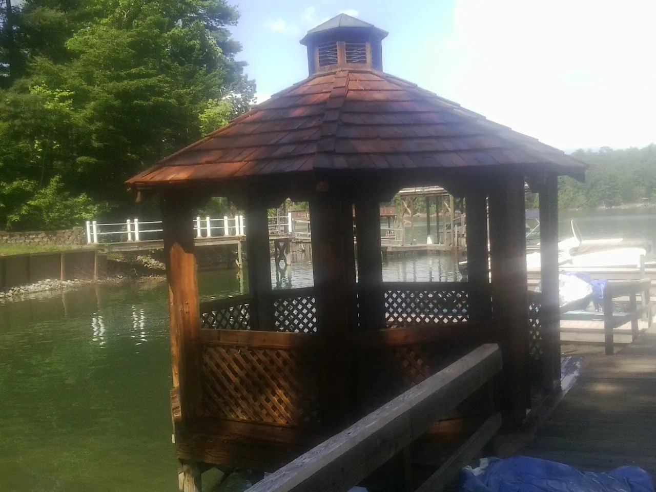 Cedar shake gazebo roof rebuilt on a lake dock in Rector