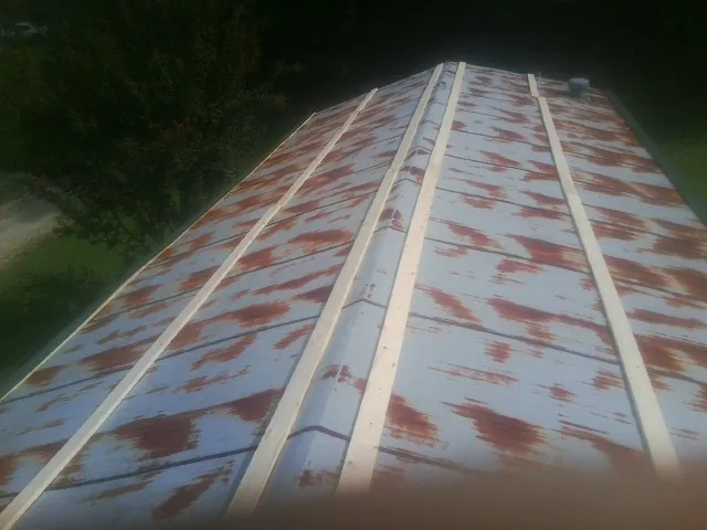 Rusted metal roof panels with new wood purlins before replacement — Storm Damage Roof Repair in Rector by Roofing Brothers